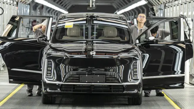 Employees inspect a Nio Inc. ES9 electric vehicle on the production line at the company's factory in Hefei, Anhui Province, China, on Tuesday, May 19, 2026. 