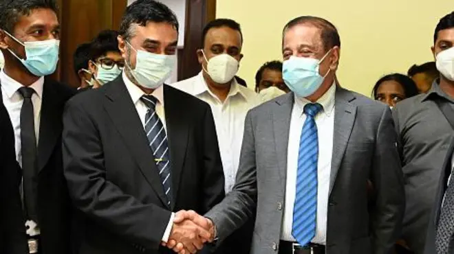 Former secretary to the Ministry of Defence, Hemasiri Fernando (centre R), and former police chief Pujith Jayasundara 