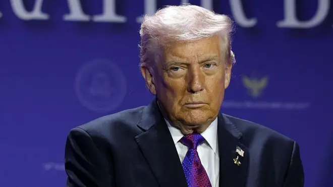 Donald Trump wit black suit looking straight