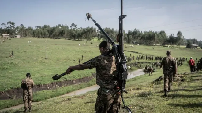 An Ethiopian National Defence Forces (ENDF) soldier carries a DShK 1938, a Soviet heavy machine gun, on his back during training in the field of Dabat, 70 kilometers Northeast of the city of Gondar, Ethiopia, on September 15, 2021.
