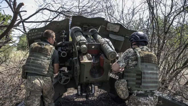 Ukrainian artillerymen check the weapons and special equipment to make them ready before they go to their duties at the frontline in Kherson, in July 2022