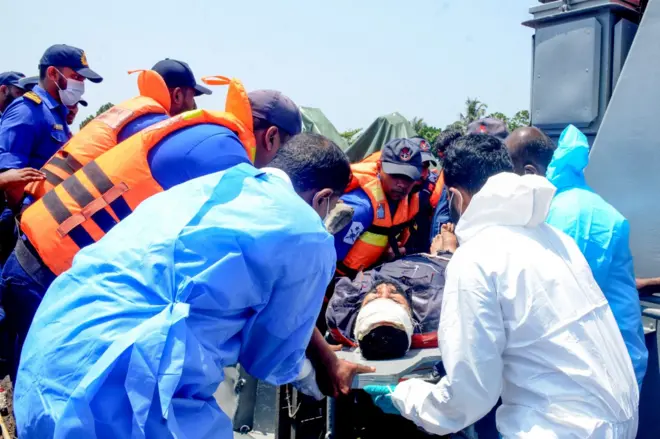 Sri Lanka Navy personnel assist Iranian sailors during a rescue operation after a distressed Iranian vessel was intercepted in waters off Galle in southern Sri Lanka. The sailors were transferred from life rafts to naval craft as part of a humanitarian rescue operation.