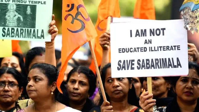 Women protesting with billboards saying, "Save Sabarimala"