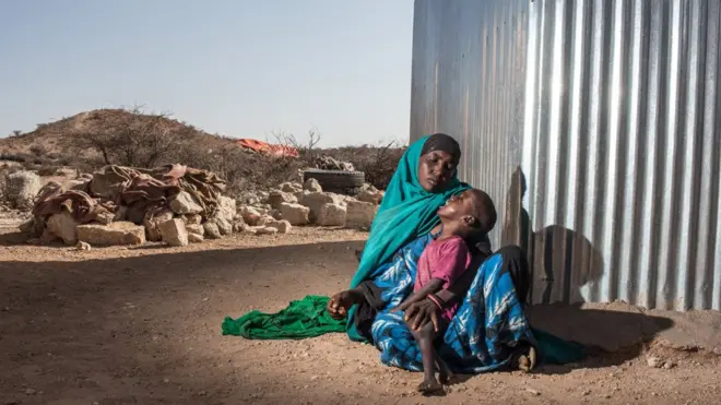 Hodan, a mother of five, holds her two year old son Harun in the town of Kiridh, Somaliland.