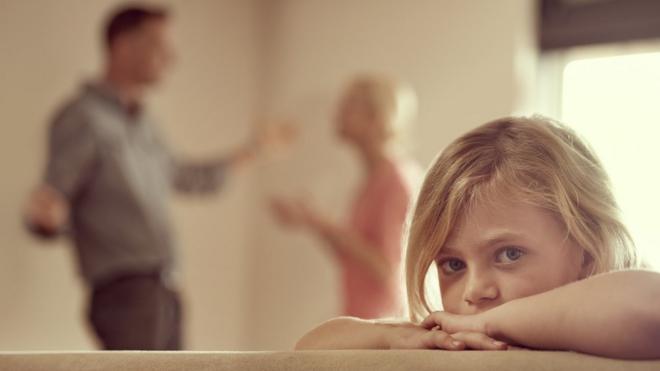 A little girl with arguing parents