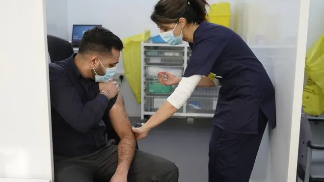 a man taking a vaccine