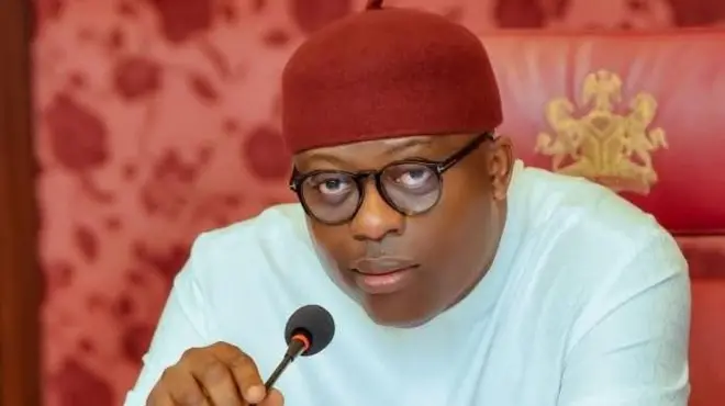 Rivers state governor Sim Fubara wear red cap and white top. E hold microphone