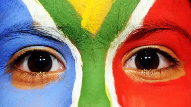 A South African girl with the national colors painted on her face poses at Mandela Square in Johannesburg on June 19, 2010 during the 2010 Football World Cup in South Africa.