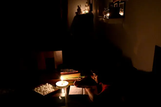 Children study in darkness, due to shortage of power supply 