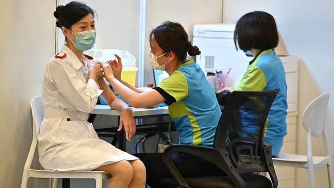 A health care worker is given a COVID-19 vaccination at a clinic in Hong Kong, China, 23 February 2021.