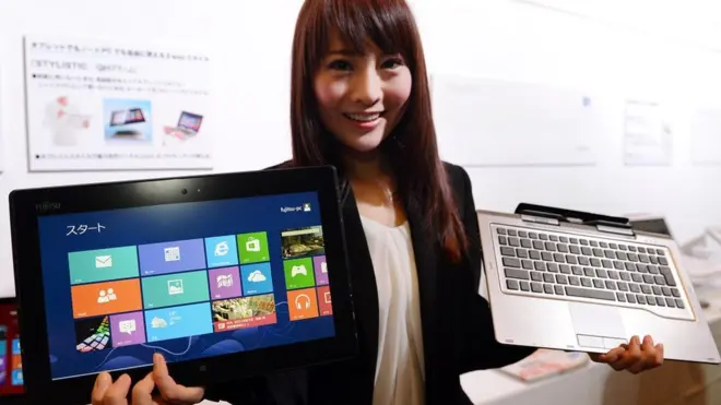 A model shows off Fujitsu's latest Windows 8 dual-style PC