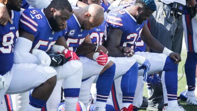 Buffalo Bills players kneel during the American National anthem before an NFL game against the Denver Broncos, 24 September 2017