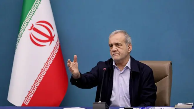 Iranian president pointing hand, wit Iran flag by di side