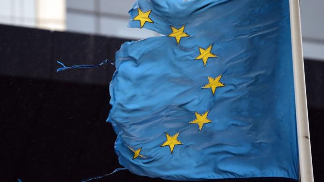 A shredded EU flag flies in Brussels