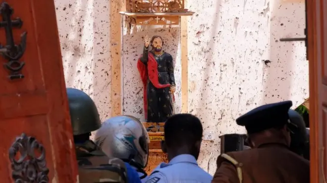 A statue of St. James is pictured after a bomb blast inside a church in Negombo