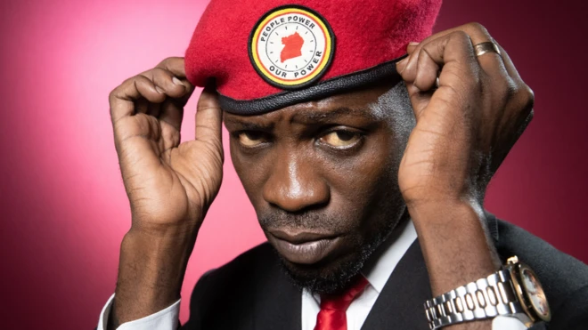 Bobi Wine adjusting his red beret