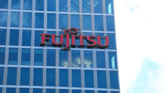 The logo of Japanese multinational information technology equipment and services company Fujitsu is seen on a skyscraper in Munich.