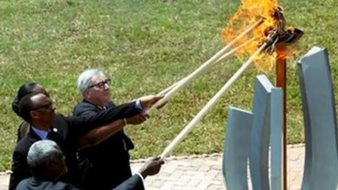 Paul Kagame and Jean-Claude Juncker help light a remembrance flame