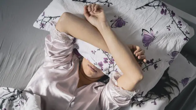 امرأة تقاوم الأرق.