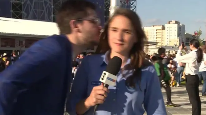 A man tried to kiss reporter Julia Guimaraes as she reports in Yekaterinburg