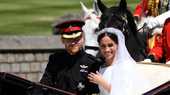 Britain"s Prince Harry, Duke of Sussex and his wife Meghan, Duchess of Sussex travel in the Ascot Landau Carriage during their carriage procession on Castle Hill outside Windsor Castle in Windsor, Britain, May 19, 2018. Paul ELLIS/Pool via REUTERS