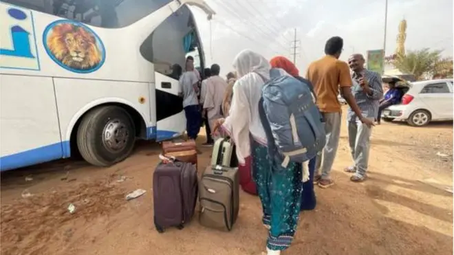 Pipo (of unknown nationality) board bus in Khartoum