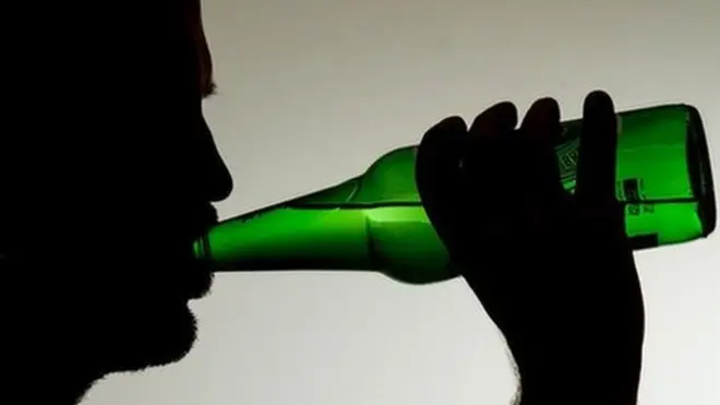 man wey dey drink beer from bottle