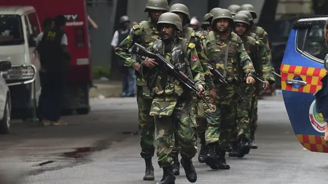 Bangladeshi army soldiers patrol a street during a rescue operation as gunmen take position in a restaurant in the Dhakas high-security diplomatic district on July 2, 2016