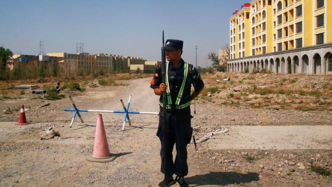 Chinese police officer outside what is formally known as a "vocational educational facility" in Xinjiang, China (file pic)