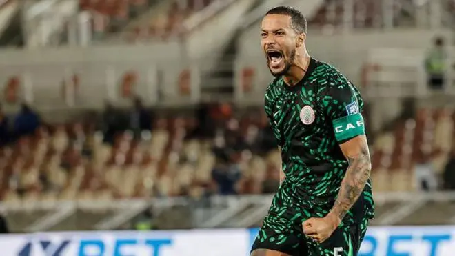 Willian Troost - Ekong wear Nigeria black and green flowered jersey, wit di CAF captain band for im arm as e dey roar.