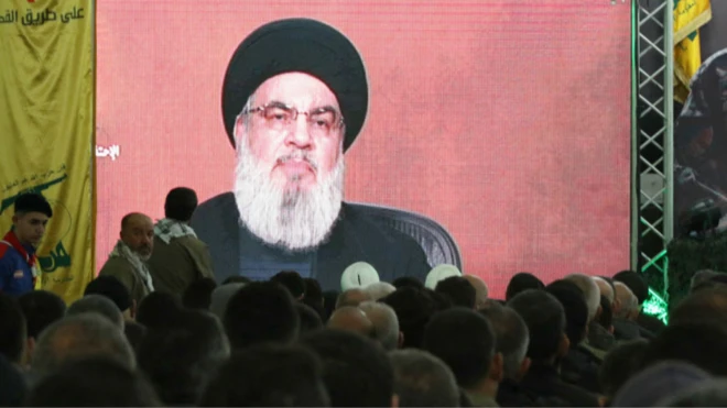Hezbollah leader Hassan Nasrallah dey show for live televised speech and head of pipo wey dey watch am dey show