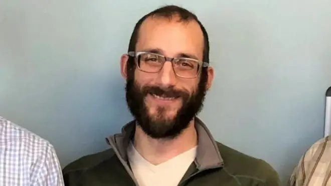 Alex Pretti wear glasses and on green sweatshirt