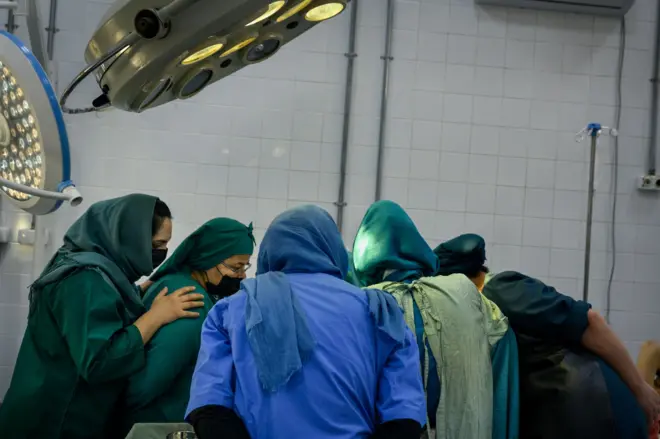 Residents watch and assist during a C-section at the Rabia Balkhi public womens hospital, one of Kabuls busiest, on October 23, 2022. Despite the ongoing training of 55 residents, the hospital is facing an uptick in patients which has spread the remaining doctors thin. (Photo by Elise Blanchard/For The Washington Post via Getty Images)