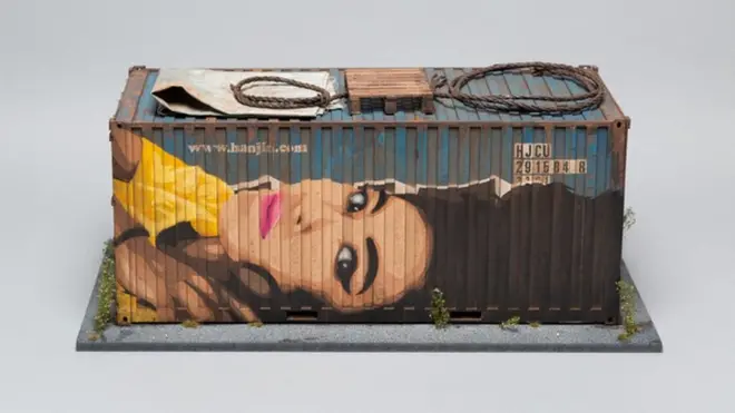 A small model of a shipping container