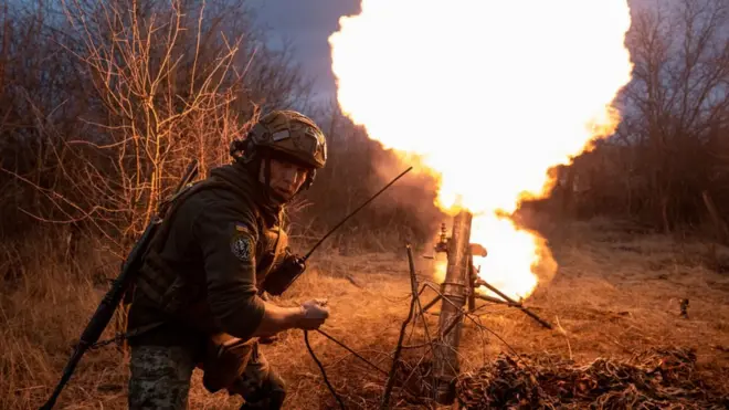 Ukrainian soldier fires a mortar