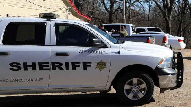 Police cars at the scene of the shooting in Mississippi