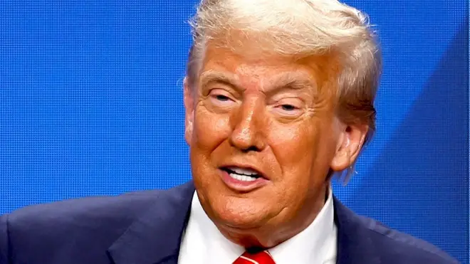 US President Donald Trump smiles during a news conference. 