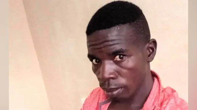 A head shot of Evans Kibet wearing a pink shirt and looking at the camera.