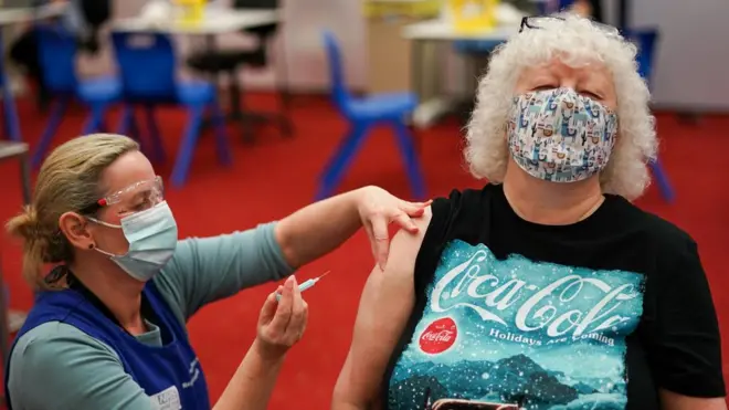 Gillian Patterson from Gateshead closes her eyes as a nurse prepares to give her her Covid-19 booster on December 08, 2021 in Newcastle upon Tyne, England.