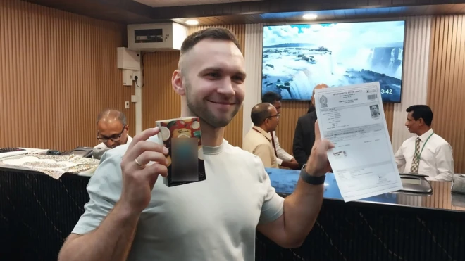 A tourist holding and displaying a license.