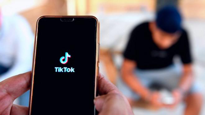 People use the TikTok app on smartphones
