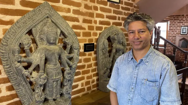 Rabindra Puri with the replica of a Saraswati sculpture