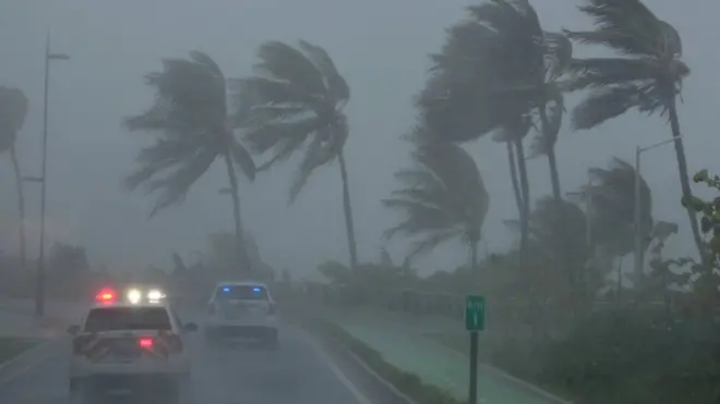 Police patrol the area as Hurricane Irma slams across islands in the northern Caribbean on Wednesday, in San Juan, Puerto Rico, 6 September