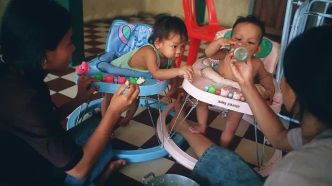 Older kids feed toddlers a thin gruel of rice porridge with