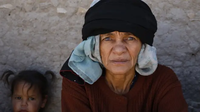 A displaced Yemeni woman and her granddaughter sit next to a makeshift shelter at a camp for Internally Displaced Persons (IDPs) on the outskirts of Sana"a, Yemen, 09 March 2022