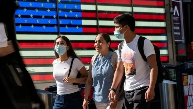 People wear masks around Times Square, as cases of the infectious coronavirus Delta variant continue to rise in New York City, New York, U.S., July 23, 2021.