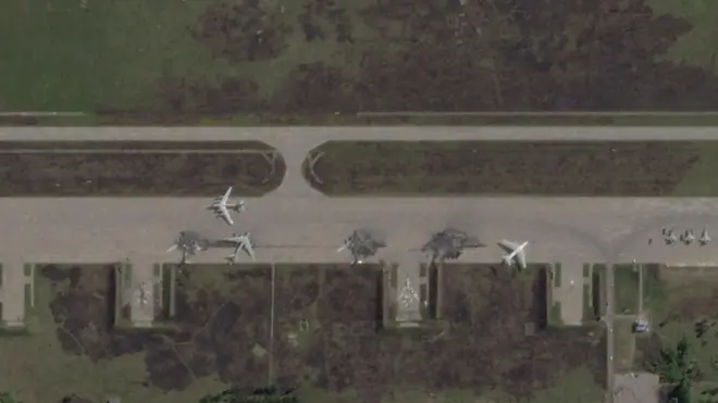 A satellite image showing damaged Russian planes on a runway. Three damaged jets are circled in the photo, which is imposed over the BBC Verify colours and accompanied by the BBC Verify logo in the top left corner. 