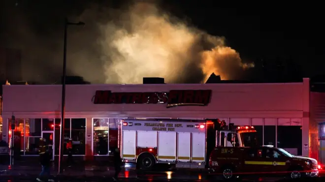 A white cloud of smoke hovers above a building