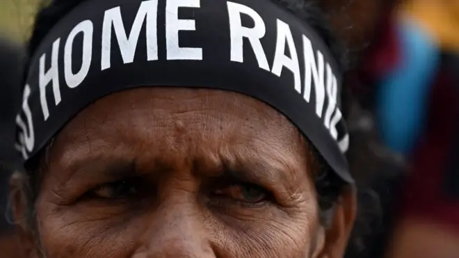 Sir Lankan demonstrator wearing a "Go Home Ranil" head band.