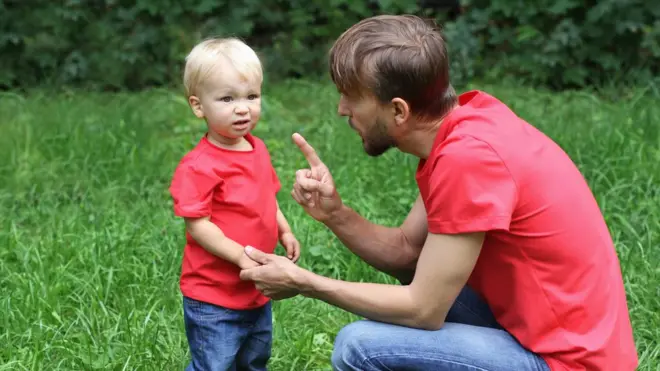 Father speaking to toddler boy
